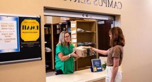 student picking up package in mail room 